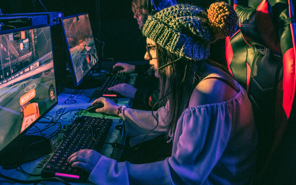 Female esports student in action playing a game