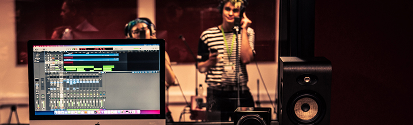 Two people recording in a music studio