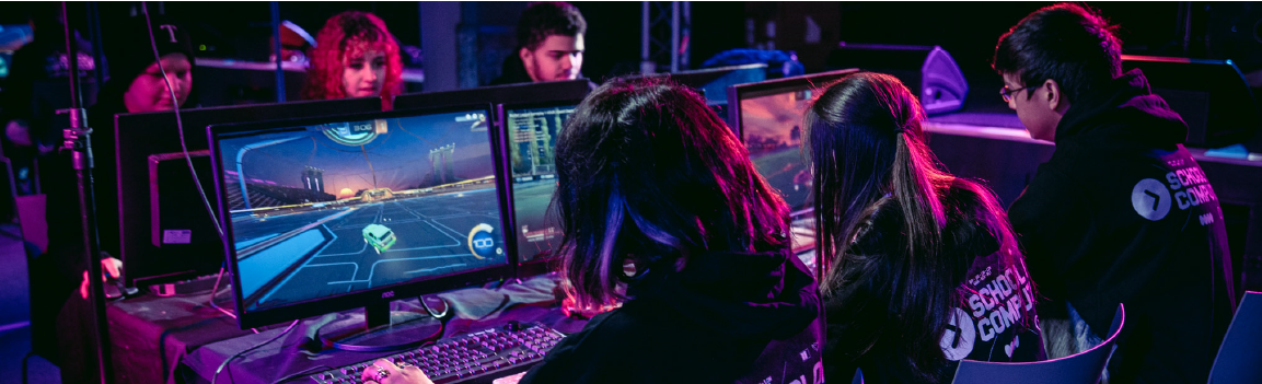 Two groups of people competing in esports at two rows of computers