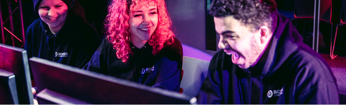 A group of people laughing at computers