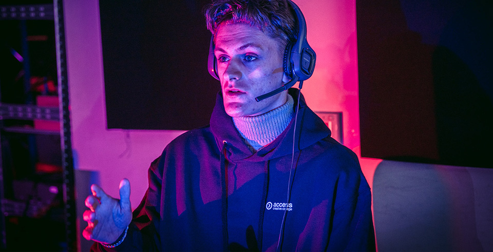 A young male talking in a headset