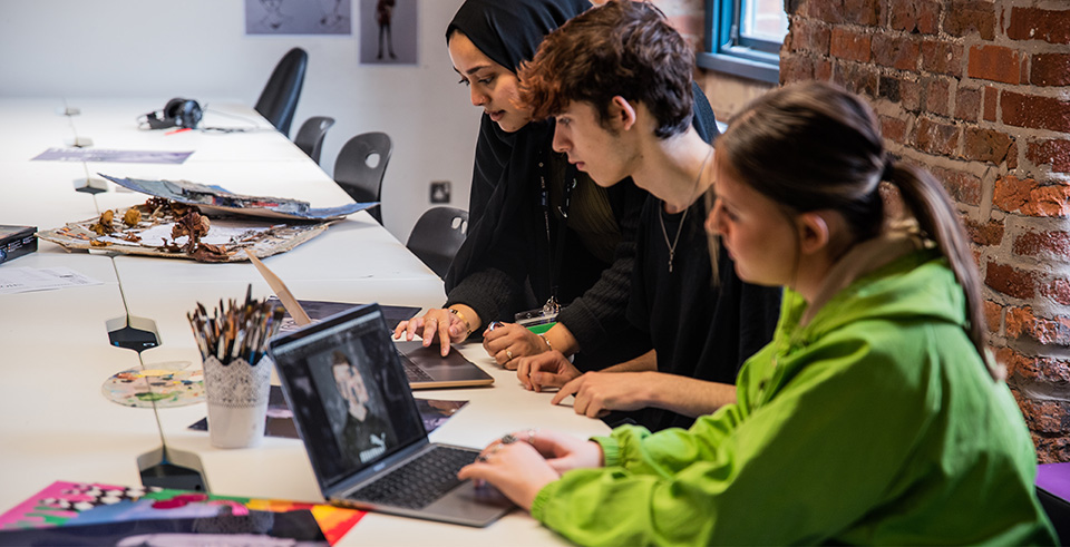 Three people working at computers