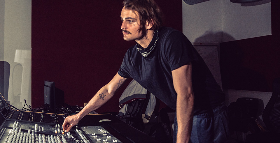 A male working at a mixing desk