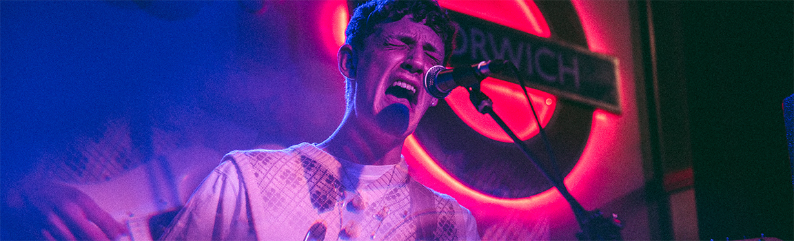A male singing on stage