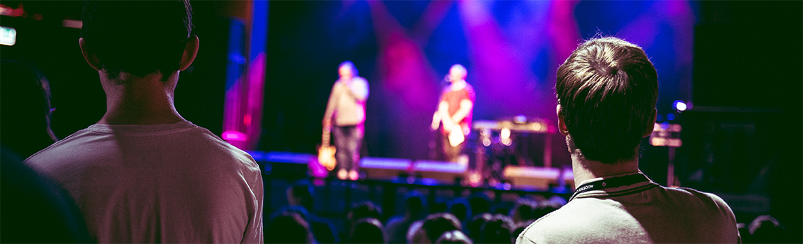 An audience watching people perform on stage