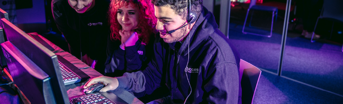 A group of people participating in an esports tournament at a row of computers