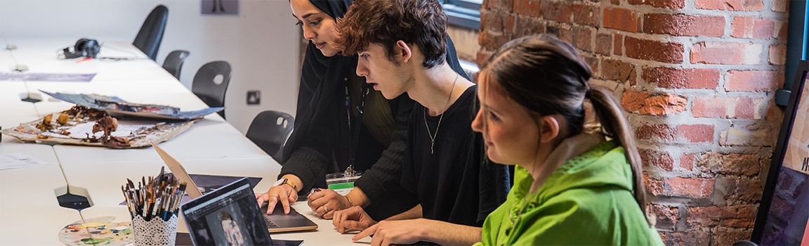 A group of people working at laptops