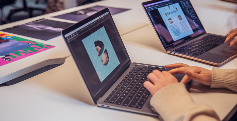 Two people working at laptops