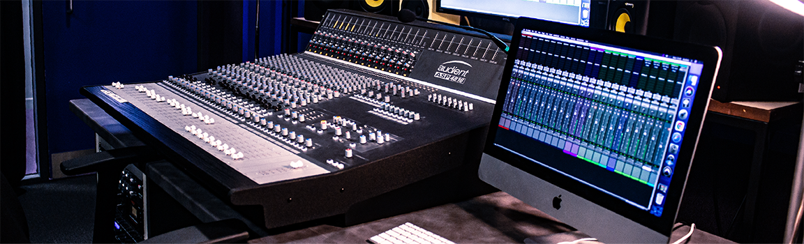 An image of a music mixing desk and computer