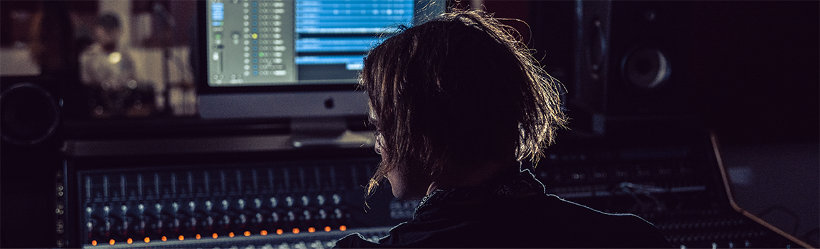 A person working at a music mixing desk