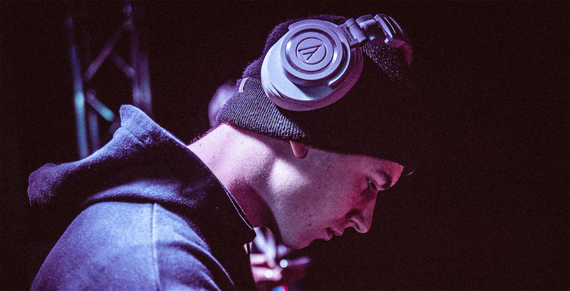 A male wearing over-ear headphones