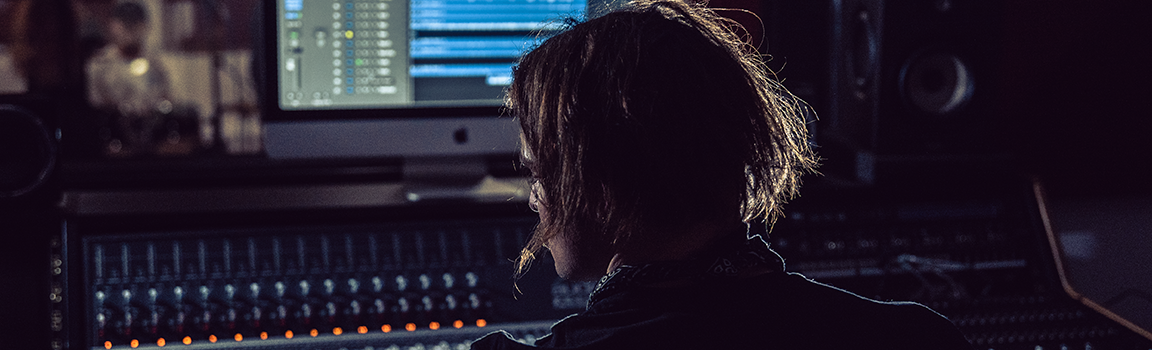 A person working at a music mixing desk
