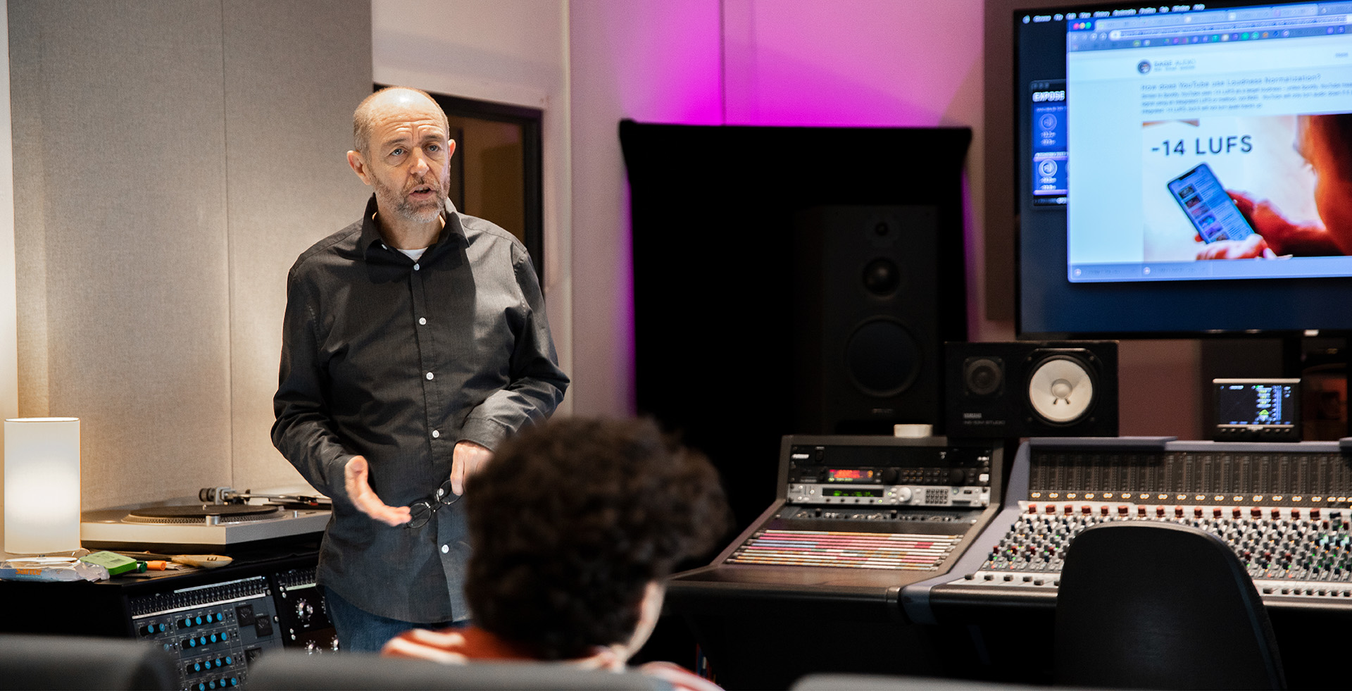 a tutor lecturing in a music studio