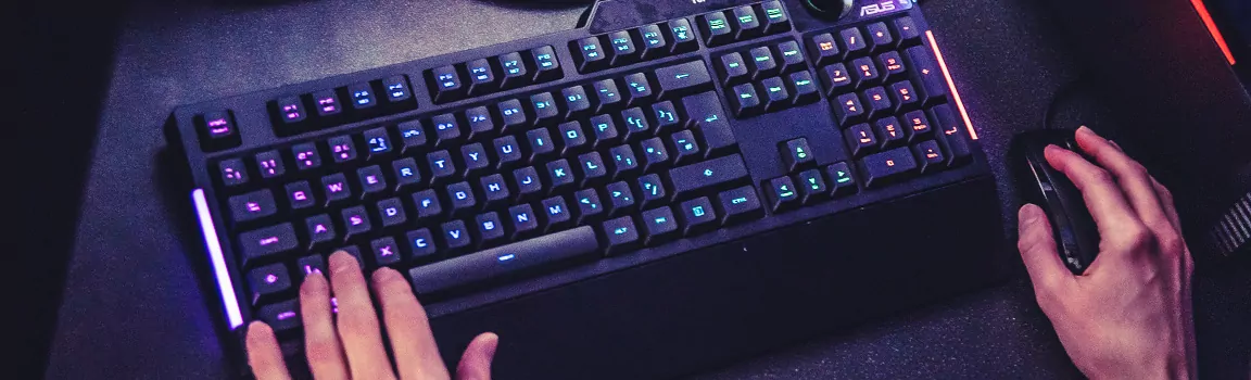 An image of a keyboard and mouse with a pair of hands using them