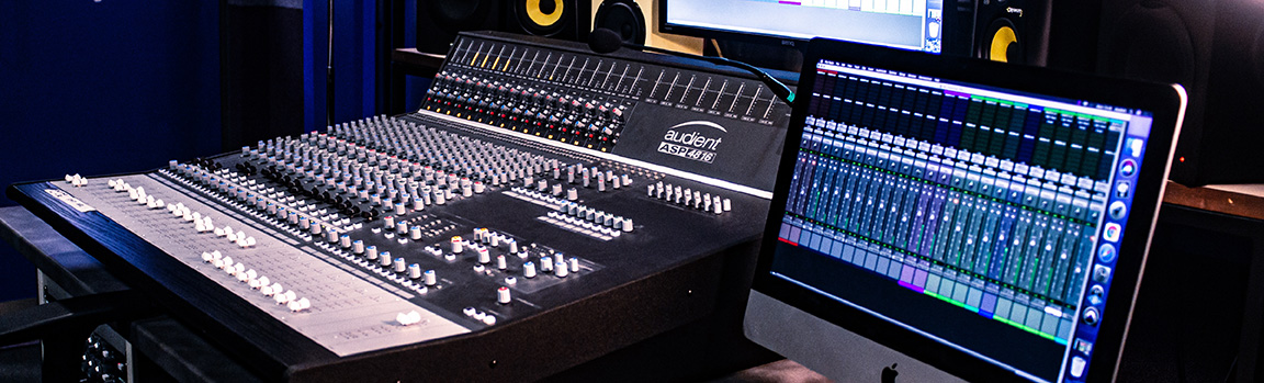 An image of a mixing desk and computer