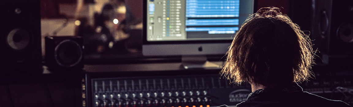 A person working at a music mixing desk