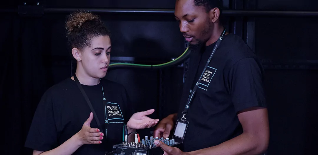 Apprenticeships: Two people look at a piece of music equipment