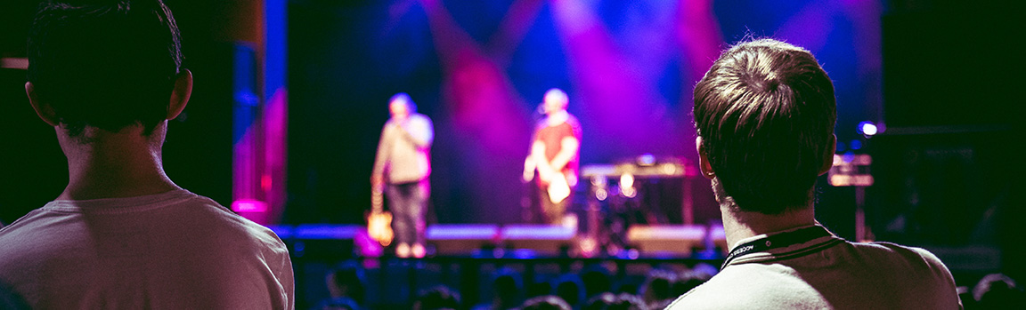 Two people watching a music performance