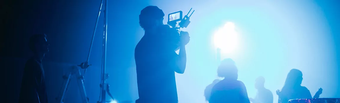 A person filming a music performance