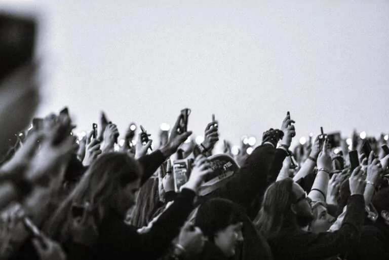 An audience with their hands in the air