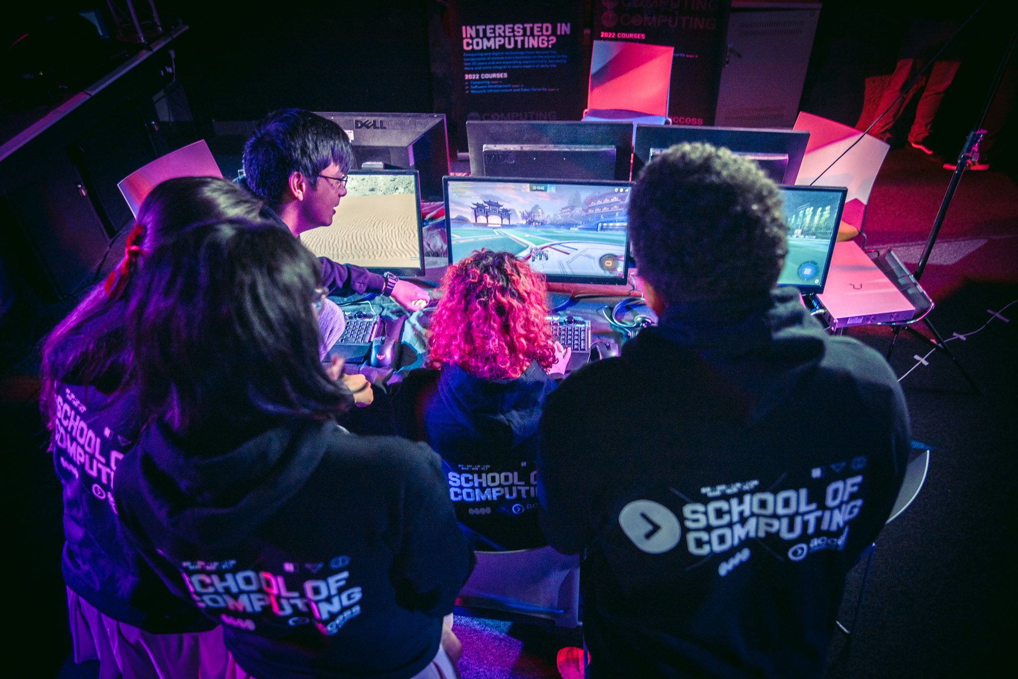 What does an esports coach do? 2 ACC Esports students surrounding computer