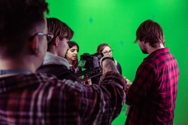 Students filming in Bristol with green screen in background