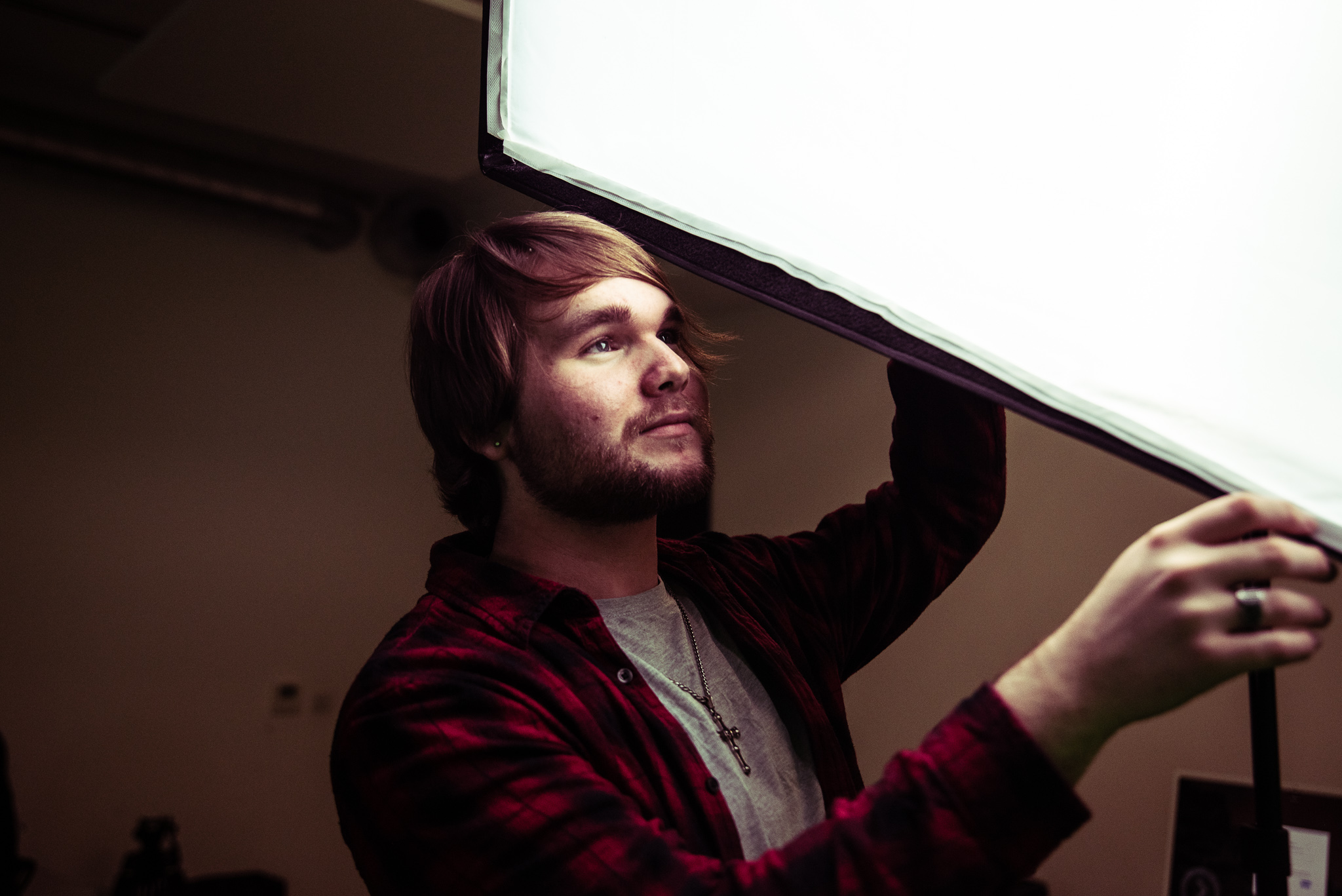 Marketing apprentice arranging lighting on set