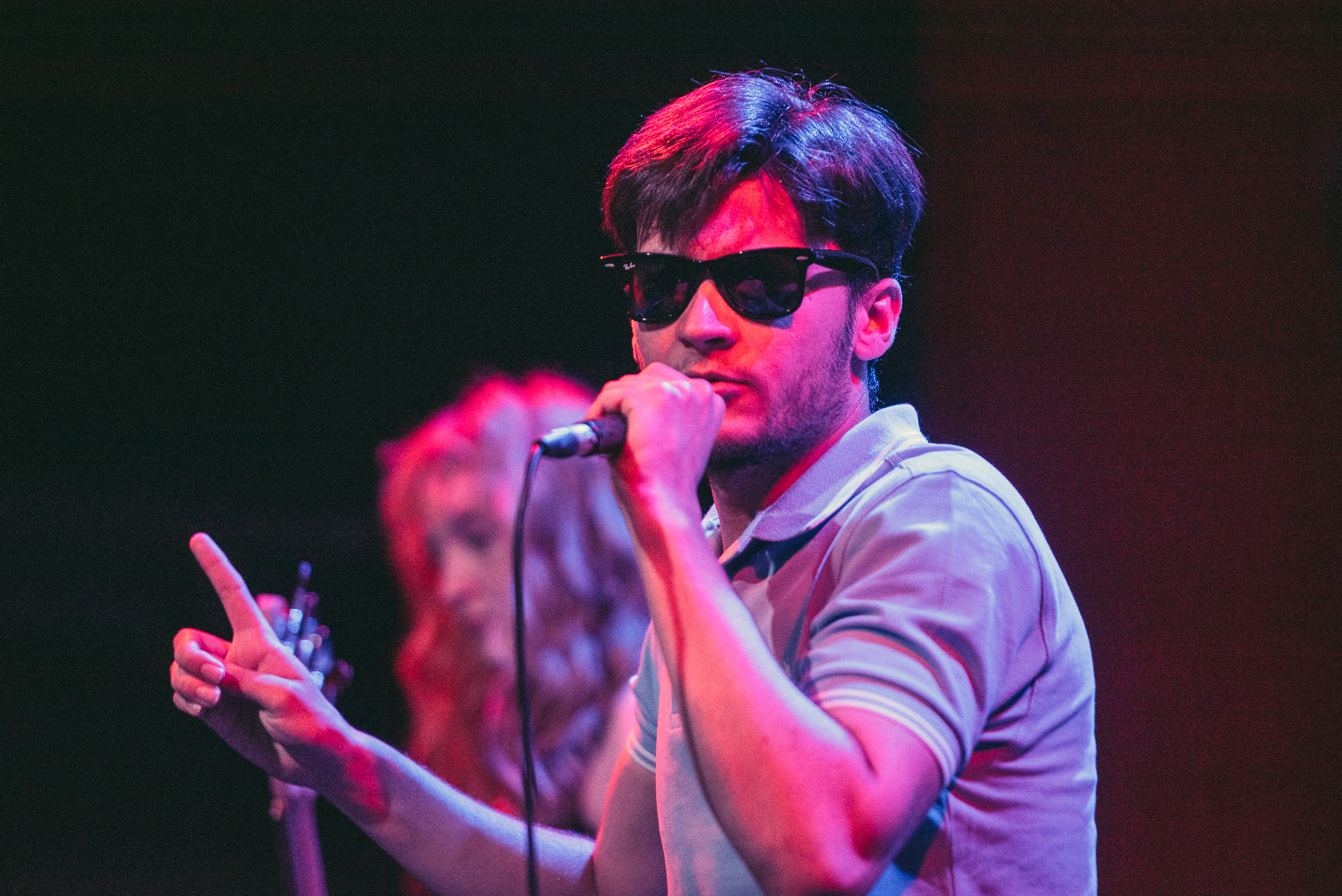 Music artist with sunglasses performing on stage