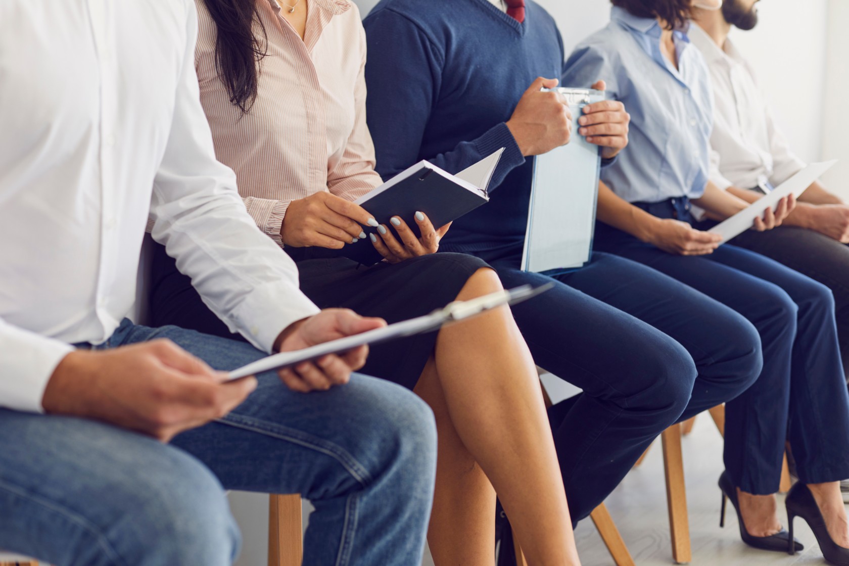 Row of apprentice recruits waiting for job interview