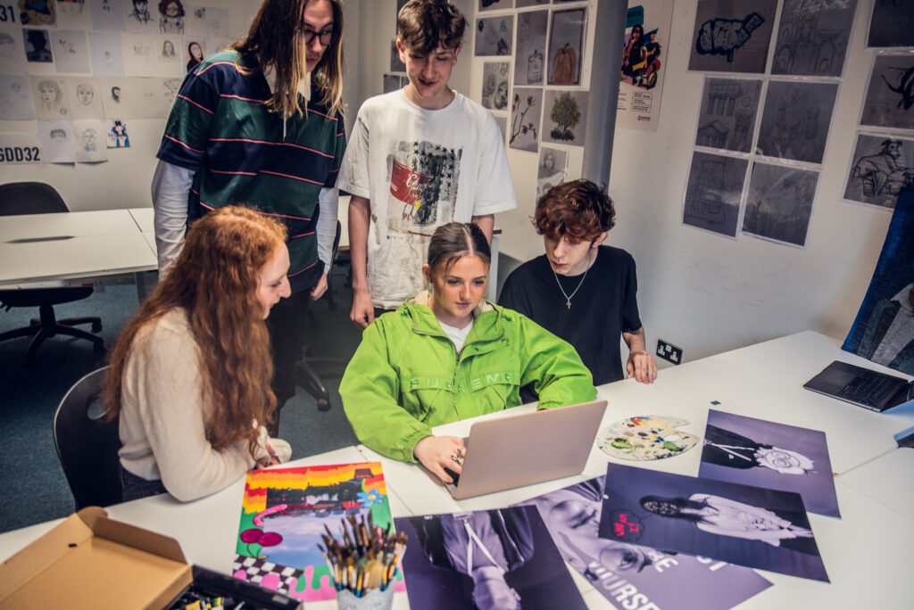 Graphic design college students working together