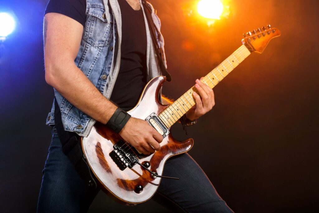 How to start a career in the music industry in Bristol 1 Man playing guitar on stage