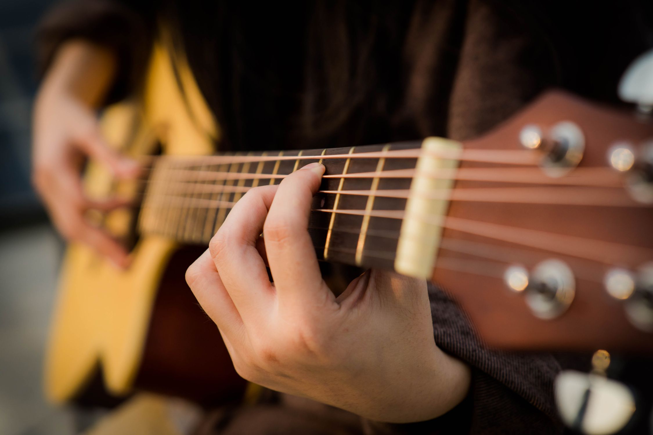 Is the music scene in Birmingham growing? 1 Person playing guitar