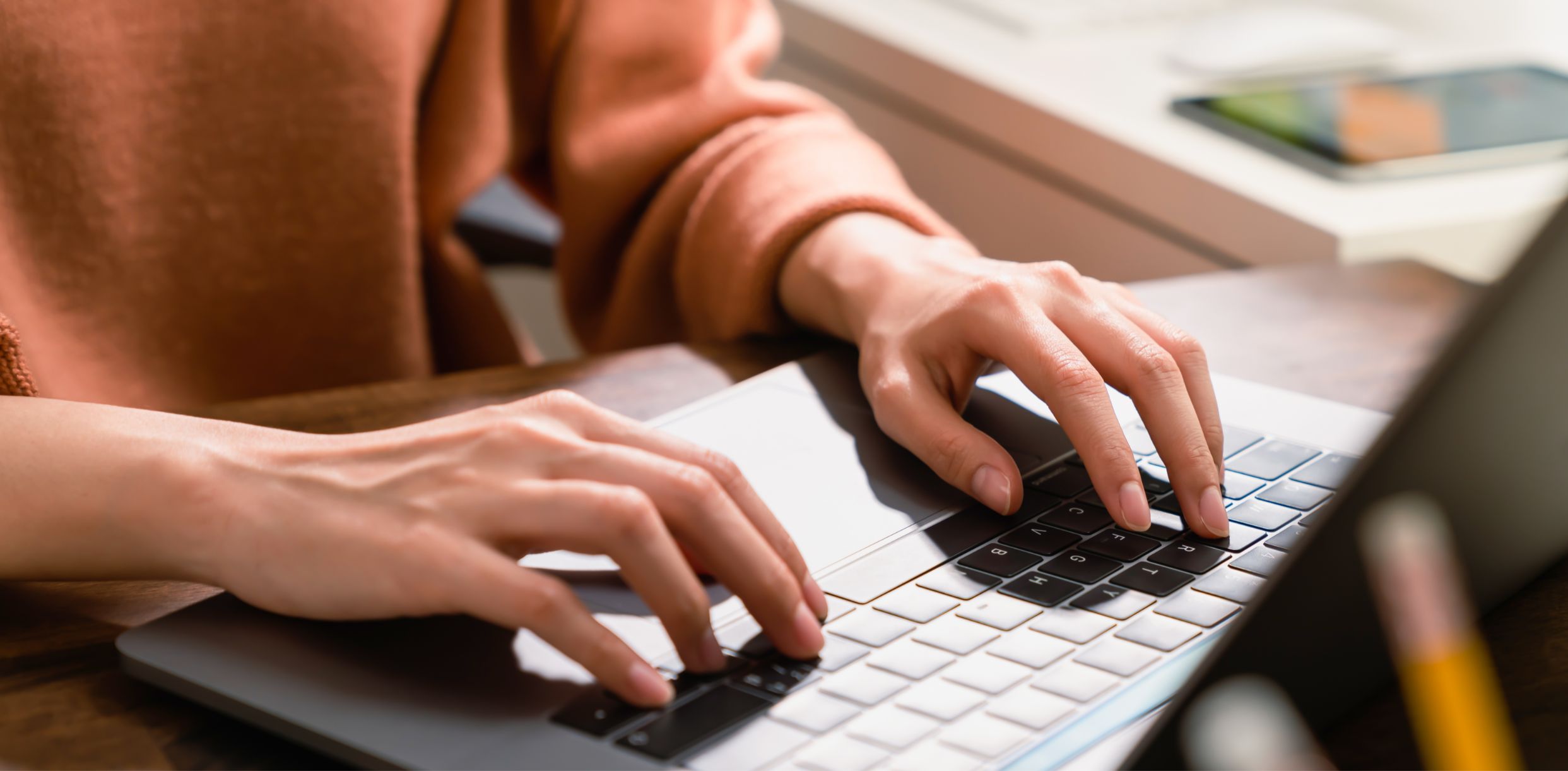 Woman typing on a laptop