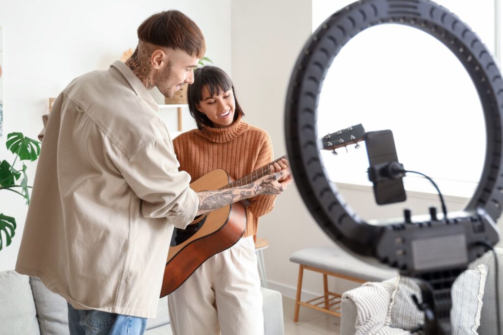 TikTok recording couple playing guitar