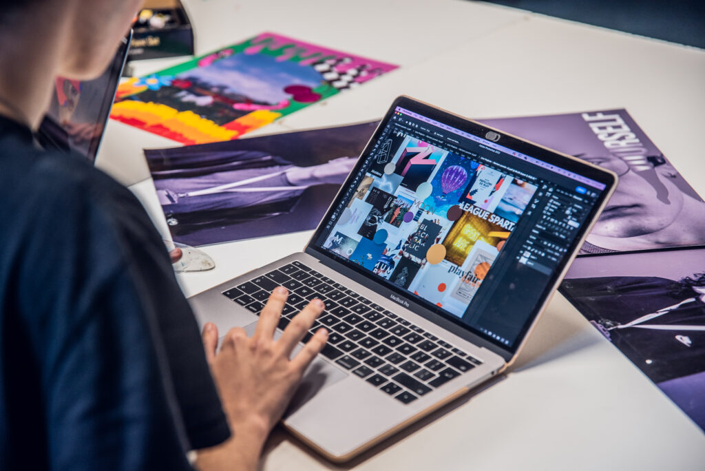 Graphic design student working on laptop