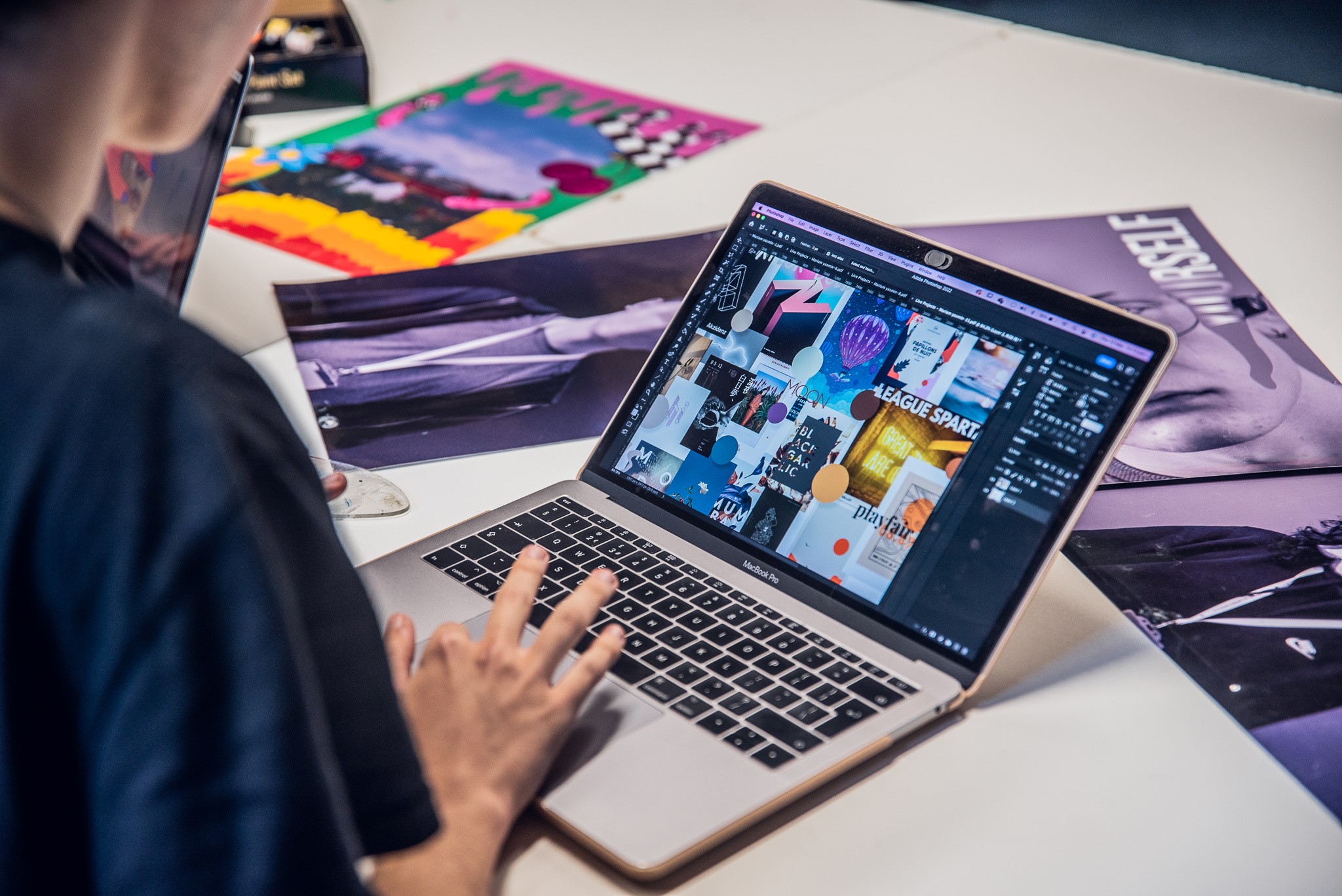 Graphic design student working on laptop