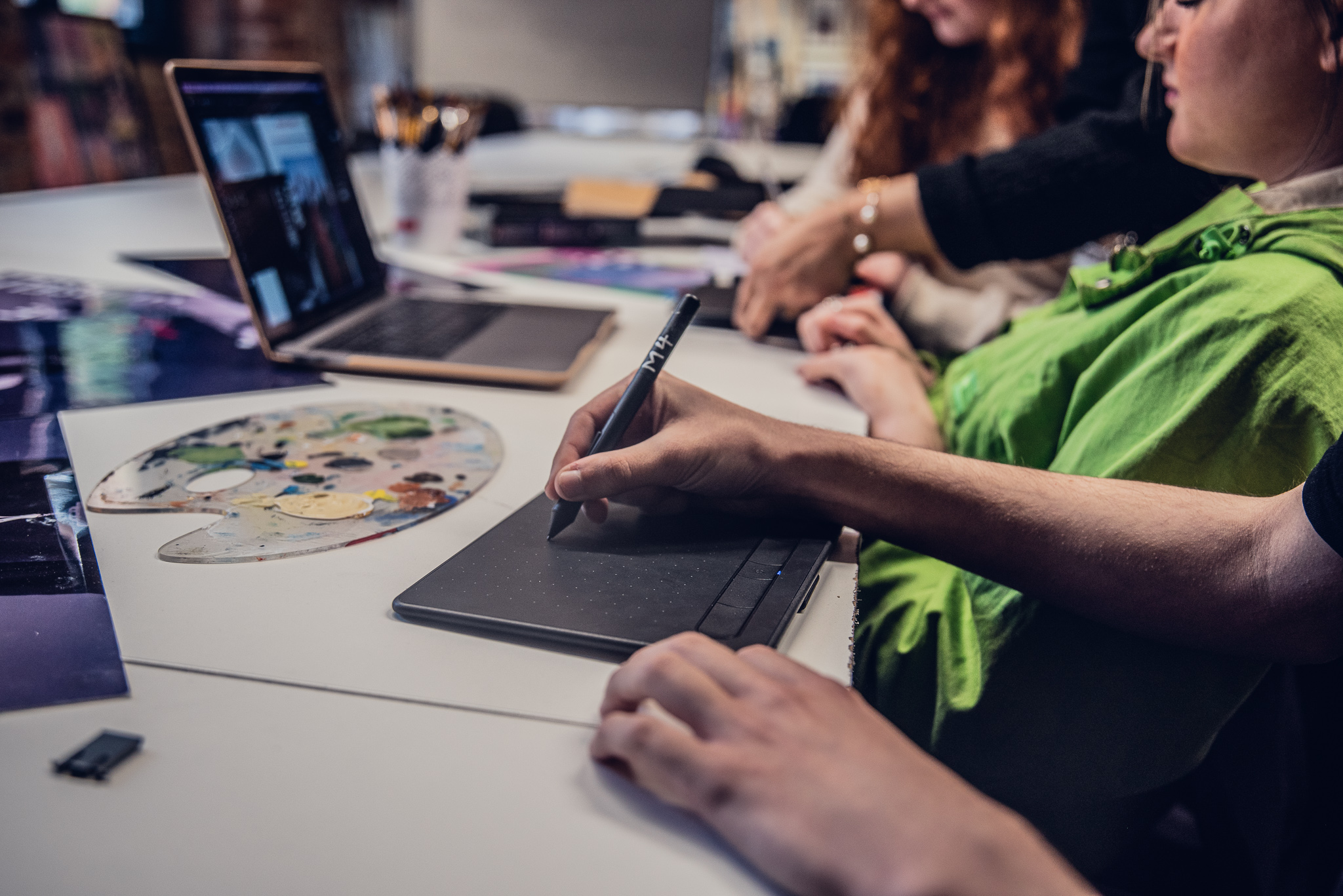 Graphic design student using tablet for design work
