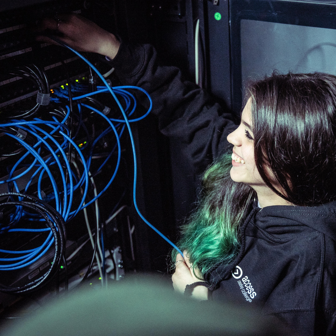 A person working with cables at a server
