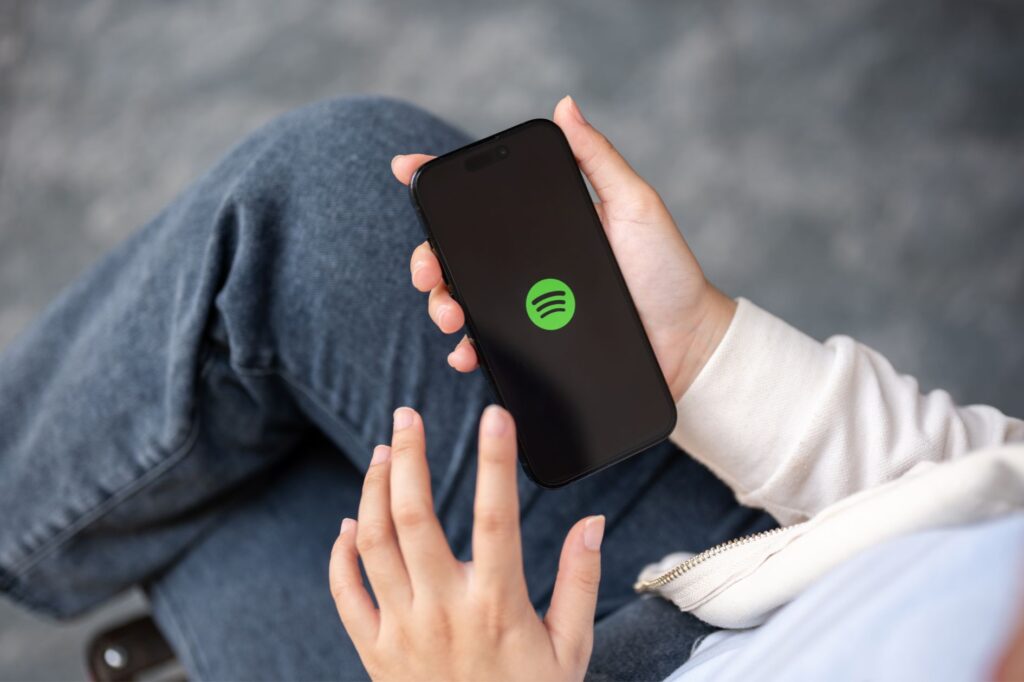 10 reasons to seriously consider a career in the music industry 2 Spotify logo on smartphone
