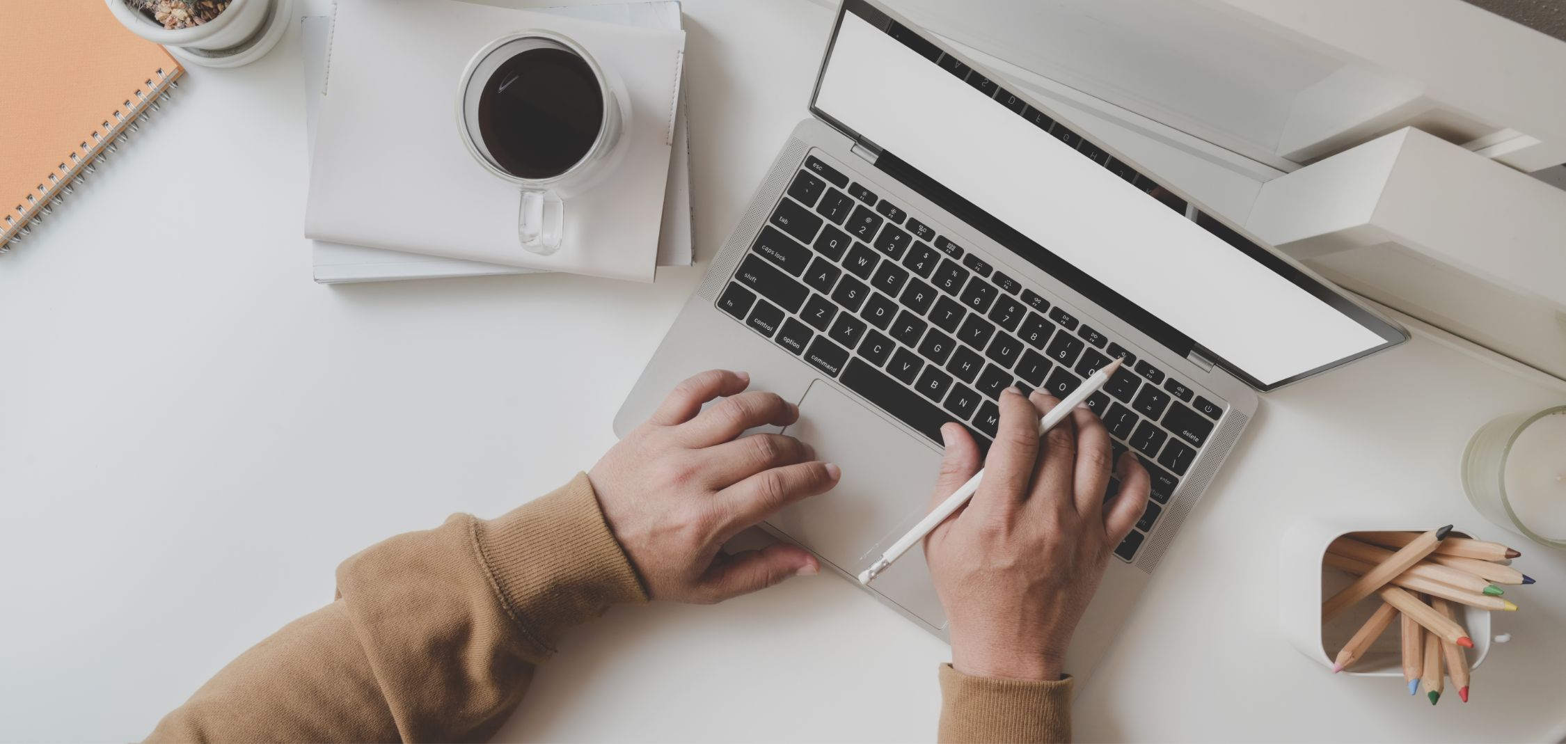 Crafting Your First CV: A Step-by-Step Guide for College Students 6 Person crafting their personal statement. Coffee on one side, pencils on the other