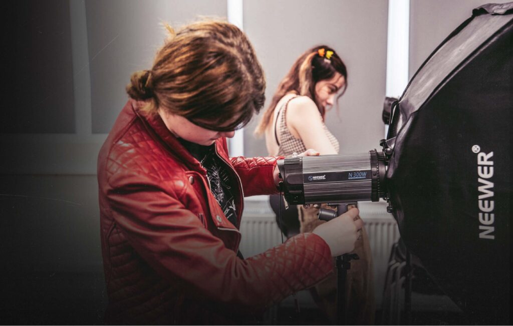 Lincoln photography student with studio lighting