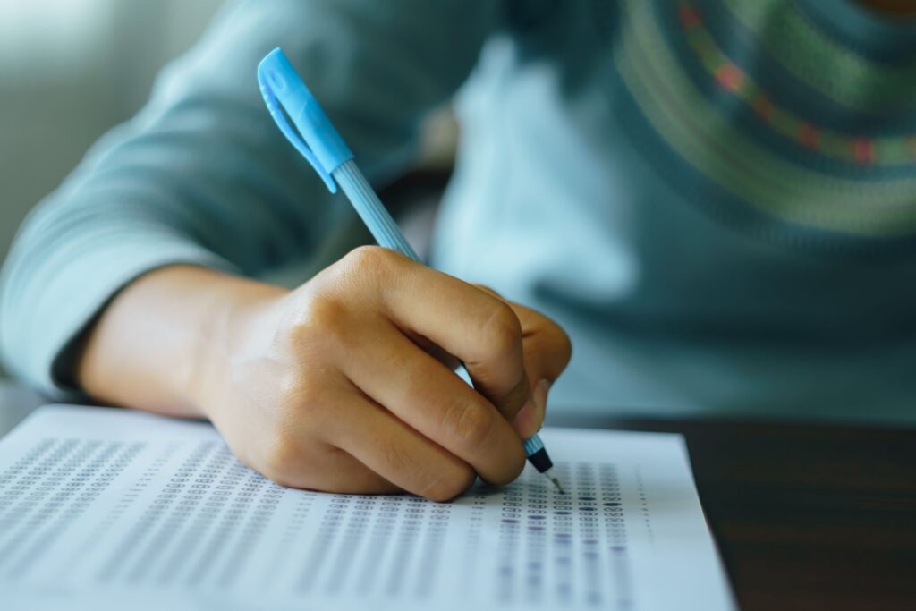 How to prepare for your GCSEs 5 Student writing on GCSE exam paper