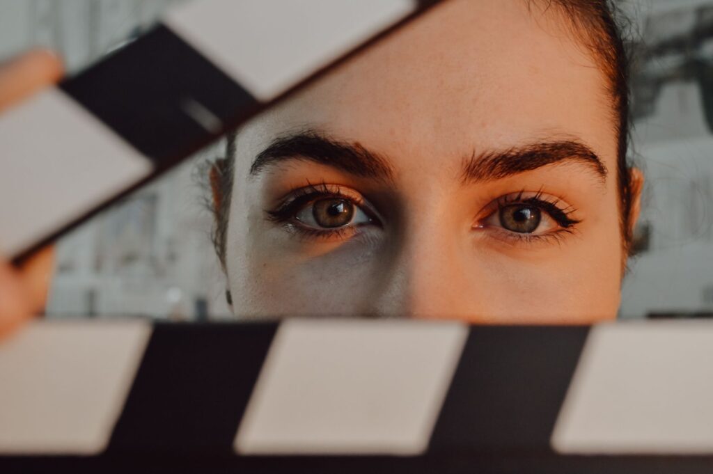 Woman with directors clapperboard