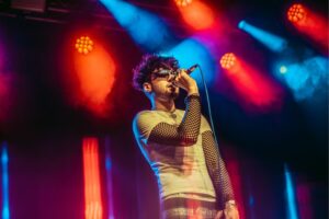 Fear of Marko singer performing on stage in Manchester, with lighting behind him