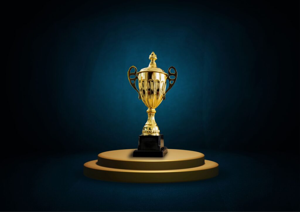 golden award trophy on a pedestal with a dark background