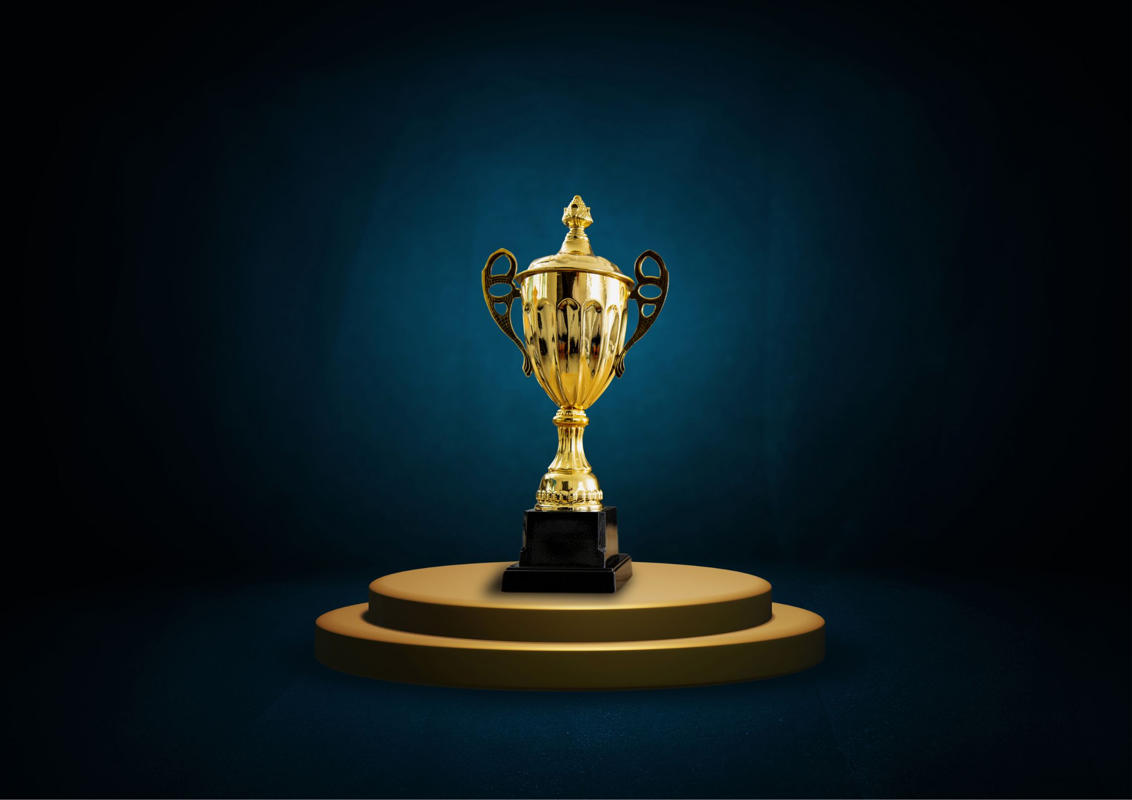 golden award trophy on a pedestal with a dark background