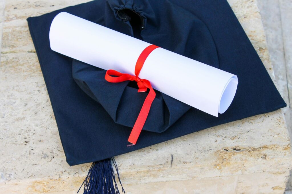 Graduation hat and degree scroll, rolled and tied up