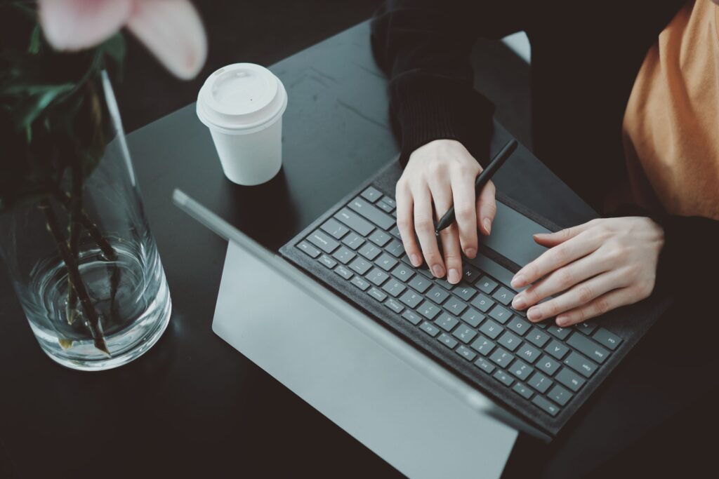 Student on work experience, typing on laptop