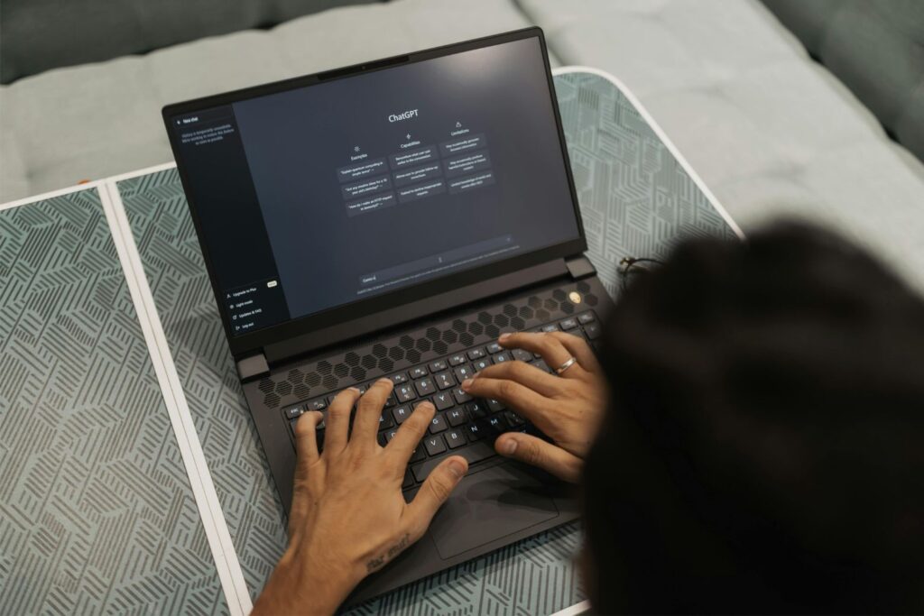 ChatGPT on laptop screen, person using it