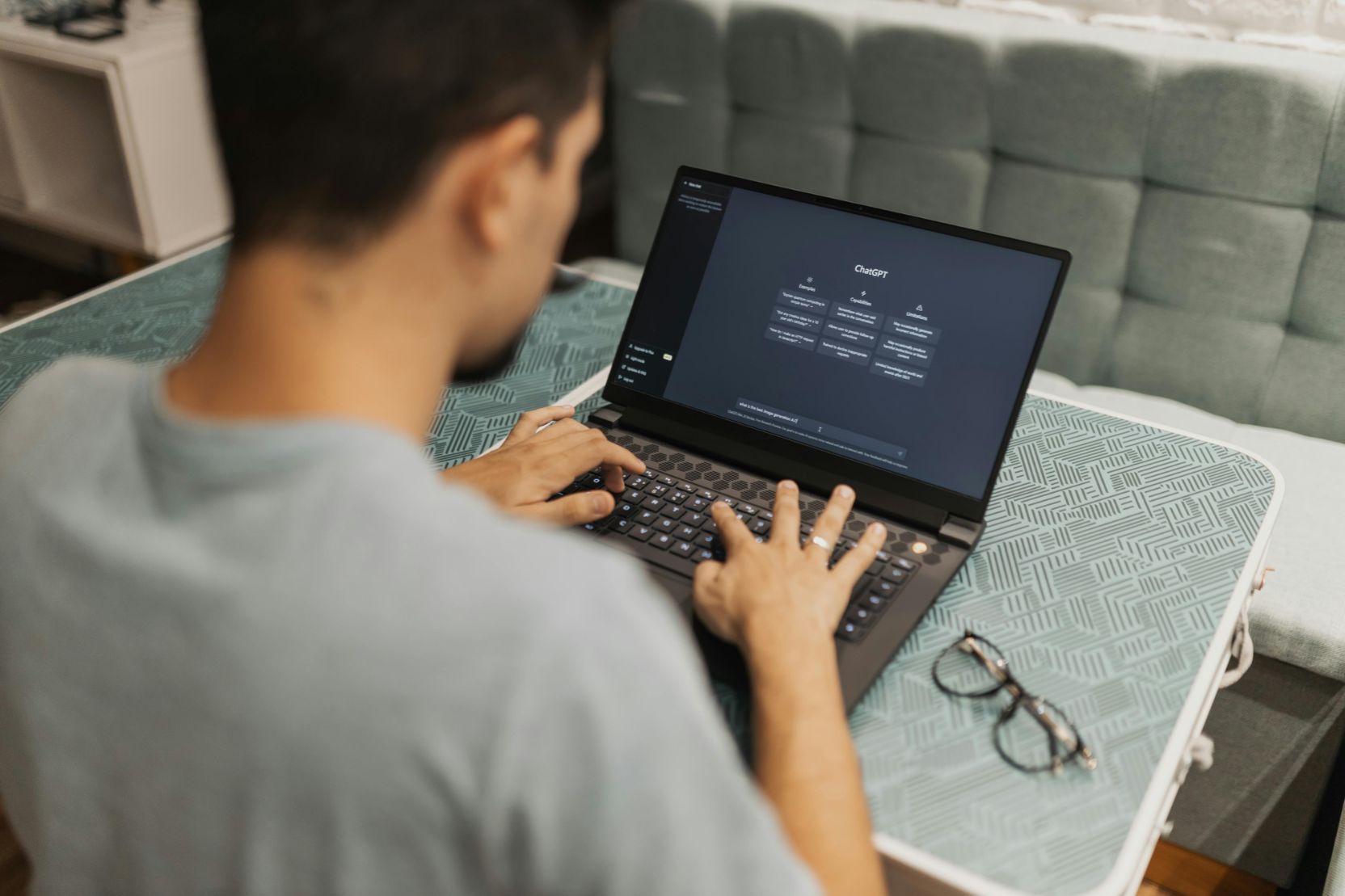 Man using ChatGPT on laptop for creative input